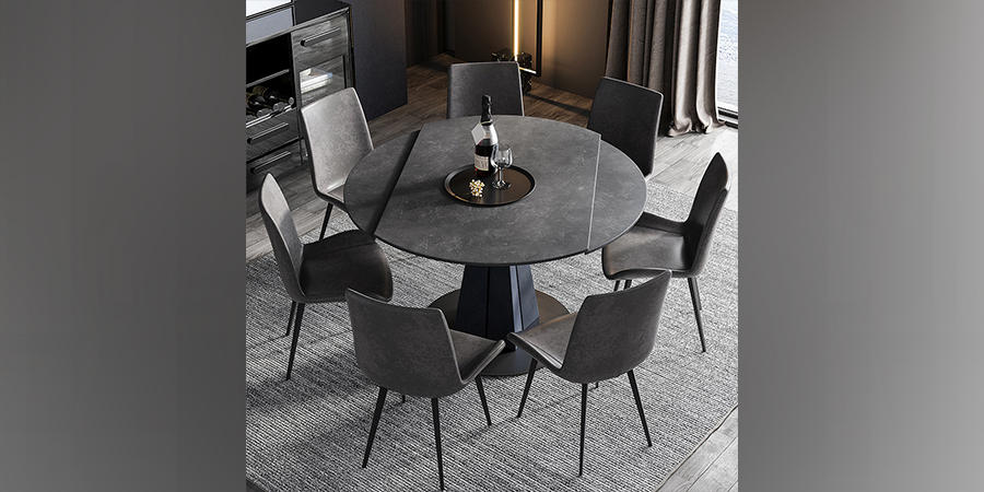 black round extendable dining table with seven black chairs