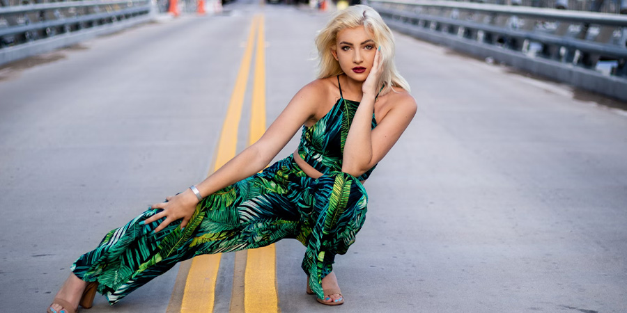 Woman posing in a casual, tropical print outfit