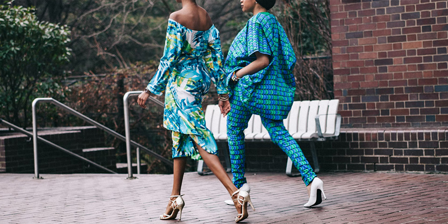 Two women decked out in bright blue hues